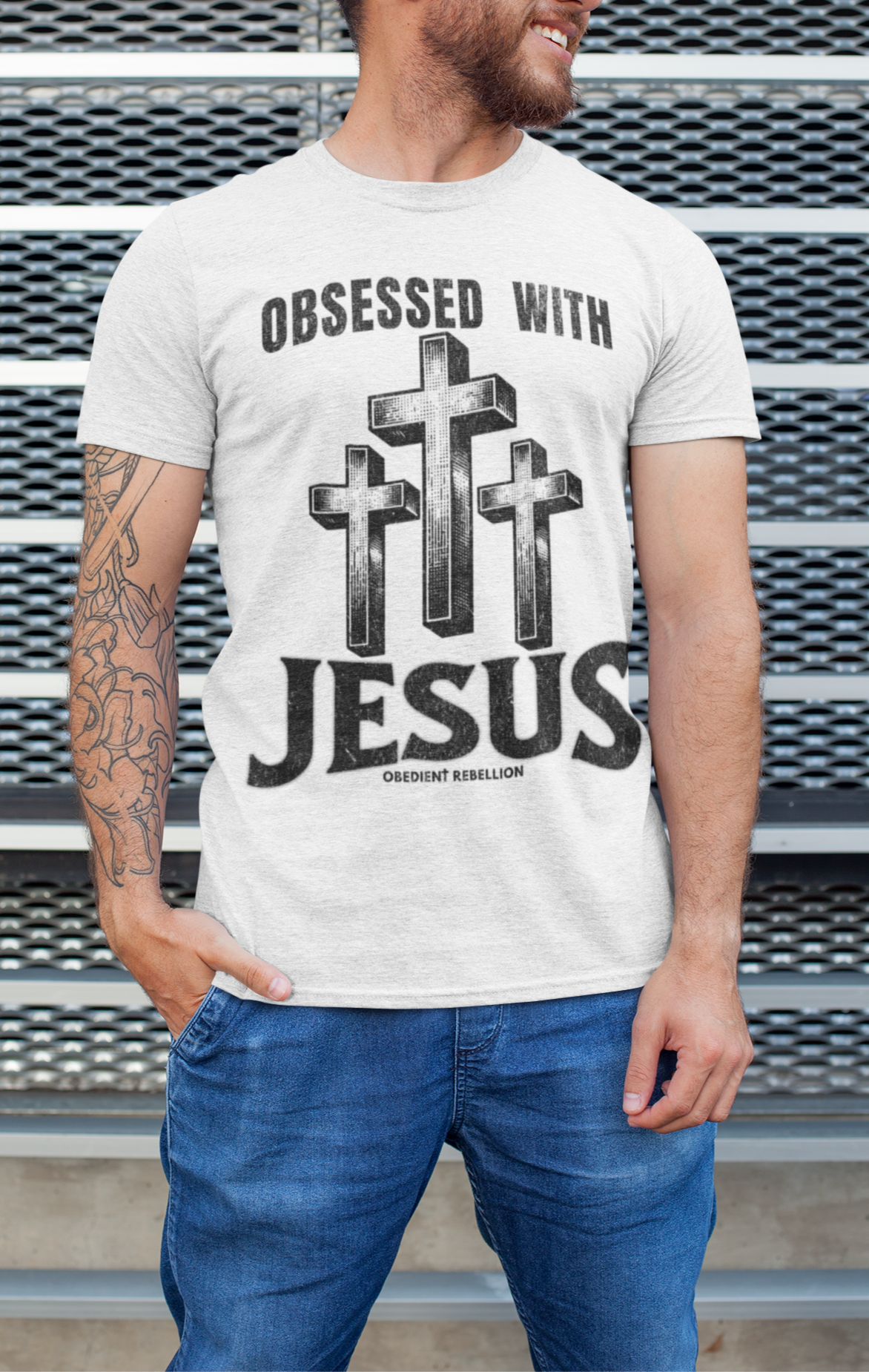 Man wearing a t-shirt with 'Obsessed with Jesus' design against a metallic background