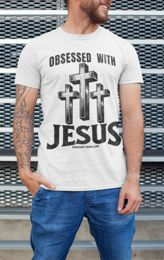 Man wearing a t-shirt with 'Obsessed with Jesus' design against a metallic background